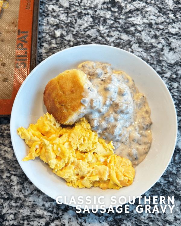 a simple southern breakfast of cheese eggs, buttermilk biscuits, and sausage gravy