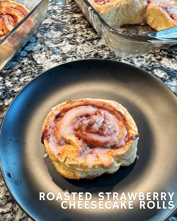 one single Roasted Strawberry Cheesecake Roll on a plate