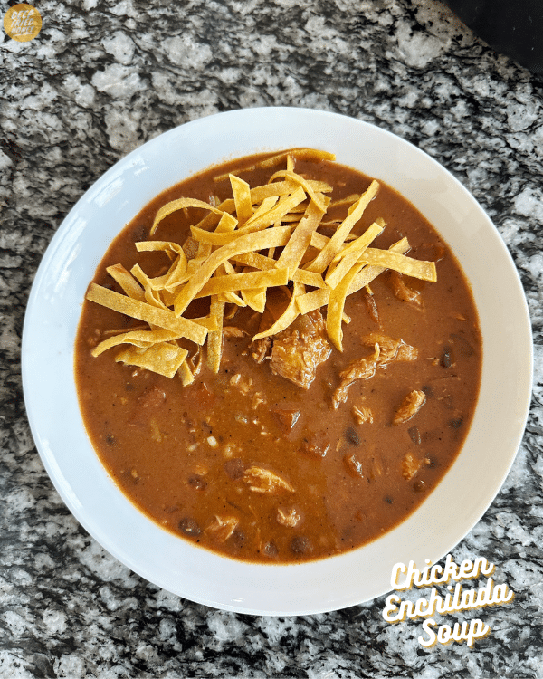 bowl of Chicken Enchilada Soup with tortilla strips on top 