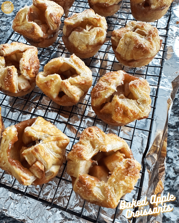 Baked Apple Croissants on a wire cooling rack over foil 